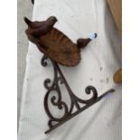 A SMALL CAST IRON WALL BRACKET BIRD BATH WITH TWO BIRD DETAIL