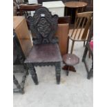 AN OAK JACOBEAN STYLE HEAVILY CARVED HALL CHAIR AND SMALL OCTAGONAL MAHOGANY TABLE, 10" ACROSS MAX