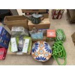 A LARGE ASSORTMENT OF ITEMS TO INCLUDE GARDEN HOSES, TRAYS AND WATERING CANS ETC
