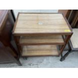 A RETRO TEAK AND OAK EFFECT THREE TIER TROLLEY, THE TOP SECTION LIFTS OFF TO FORM SEPARATE TABLE,