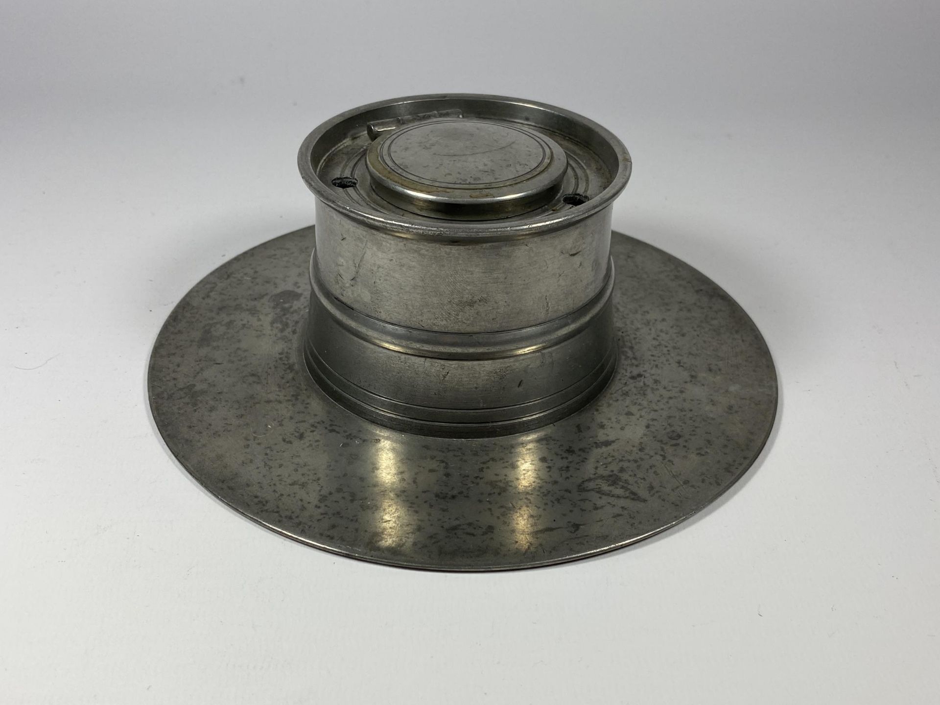 AN ANTIQUE PEWTER INKWELL WITH CERAMIC INNER LINER