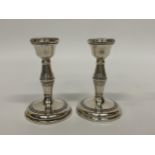 A PAIR OF BIRMINGHAM HALLMARKED SILVER DWARF CANDLESTICKS, MAKER B & CO