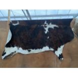 A LARGE ANIMAL HIDE RUG