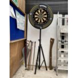 A WINMAU DARTBOARD ON AN ADJUSTABLE TRIPOD STAND WITH SIX DARTS AND A WINMAU XTREME FOAM DARTBOARD