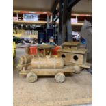A VINTAGE WOODEN TRAIN AND A PAINTED MOTORCAR WITH DRIVER