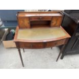 A MAHOGANY LADIES DESK WITH INSET LEATHER TOP AND FLUTED SUPPORTS
