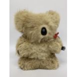 A VINTAGE WIND UP MOHAIR MUSICAL KOALA SOFT TOY