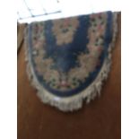 A BLUE PATTERNED FRINGED RUGS