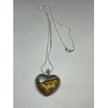 A SILVER NECKLACE WITH A SILVER AND A POSSIBLY AMBER HEART SHAPED PENDANT IN A PRESENTATION BOX