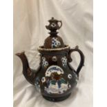 A LARGE TREACLE GLAZED BARGEWARE TEAPOT - A/F HEIGHT APPROX 33CM