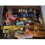 A COLLECTION OF VINTAGE TOY WAGONS AND CRANES