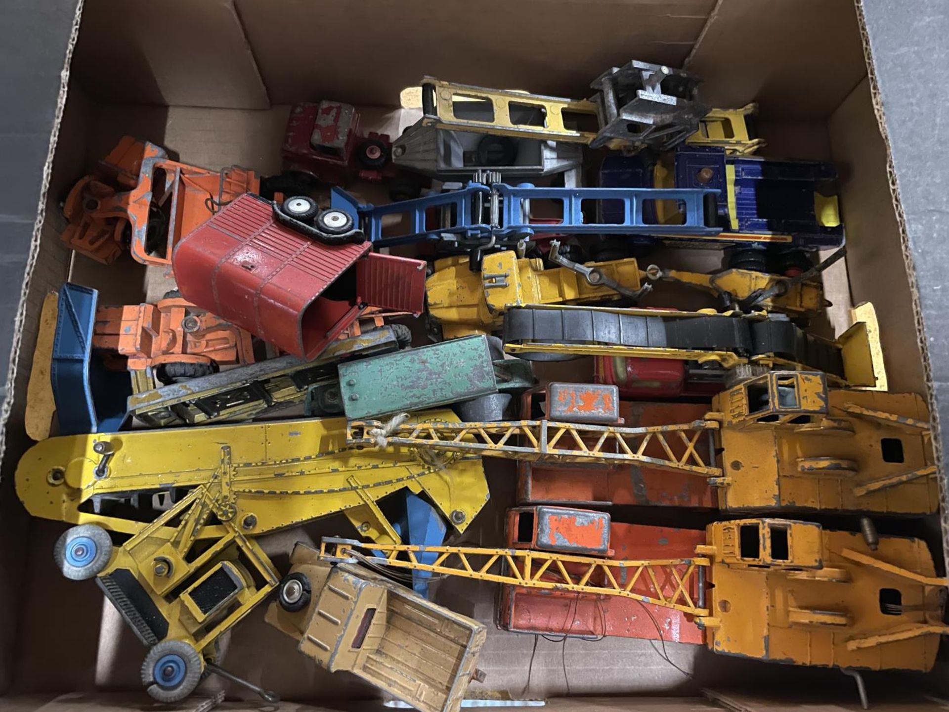 A COLLECTION OF VINTAGE TOY WAGONS AND CRANES