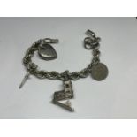 A HEAVY SILVER ROPE CHARM BRACLET WITH FIVE CHARMS IN A PRESENTATION BOX