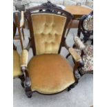 A VICTORIAN WALNUT FIRESIDE CHAIR ON TURNED AND FLUTED FRONT LEGS AND BUTTON BACKS