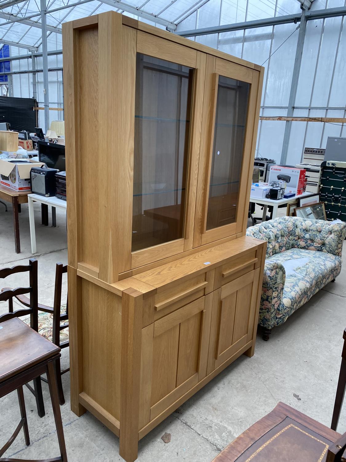 A MODERN OAK MARKS & SPENCER TWO DOOR GLAZED BOOKCASE ON BASE, 48" WIDE