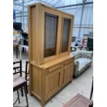 A MODERN OAK MARKS & SPENCER TWO DOOR GLAZED BOOKCASE ON BASE, 48" WIDE