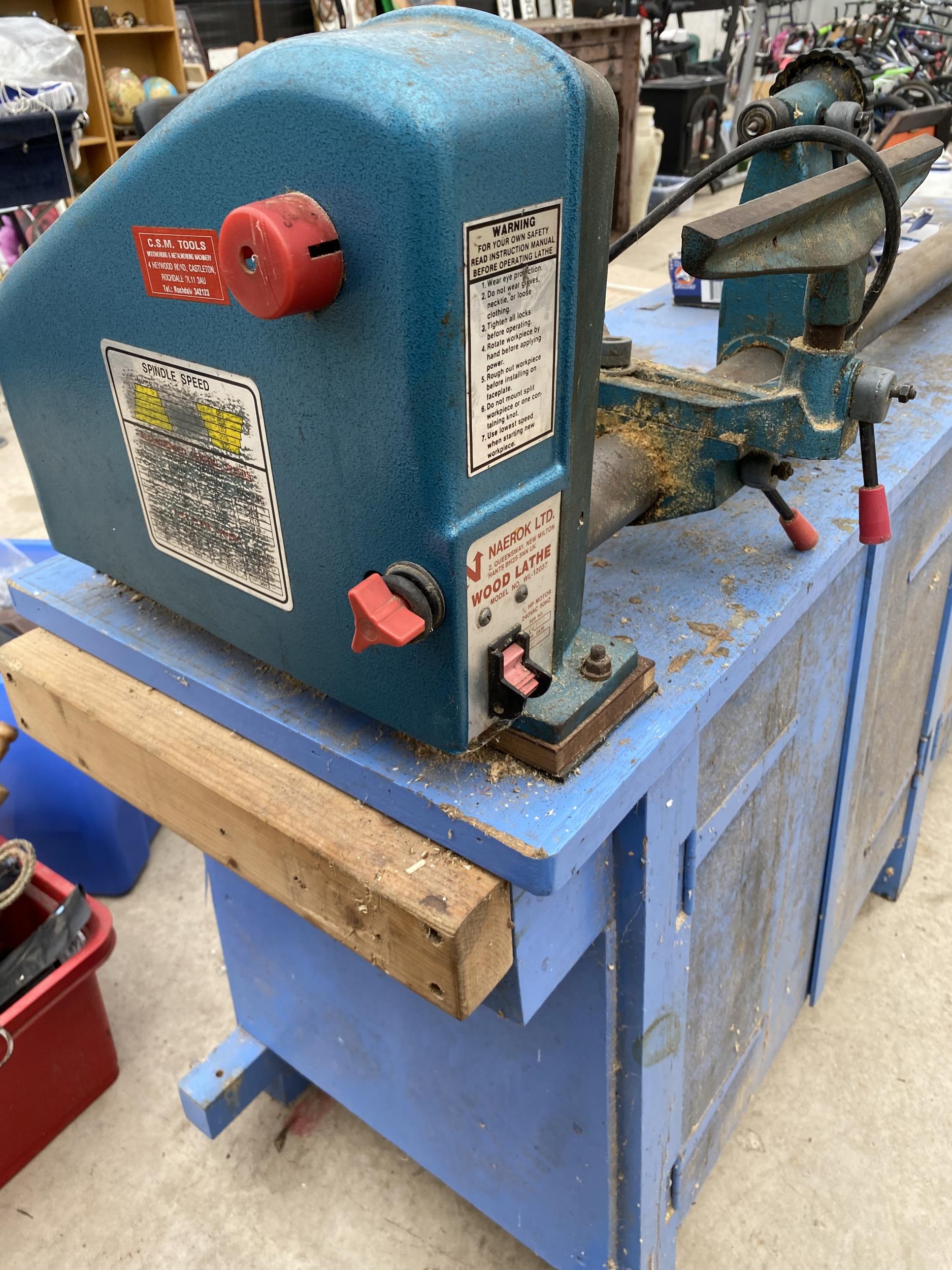 A NAEROK LTD. WOOD LATHE FIXED TO A WOODEN WORK BENCH ENCLOSING TWO LOWER CUPBOARDS AND FOUR - Image 6 of 8