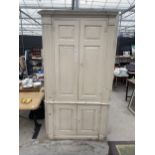 A WHITE PAINTED GEORGE III FULL LENGTH CORNER CUPBOARD WITH FOUR DOORS, THE UPPER SECTION HAVING