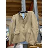 AN EQUIPORT SIZE 8 SHOWING JACKET, TWEED STYLE PATTERN, UNION JACK BADGE ON THE ARM, BACK VENTS,