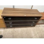 A MODERN CHEST OF THREE DRAWERS WITH SMOKED GLASS FRONTS, 49" WIDE
