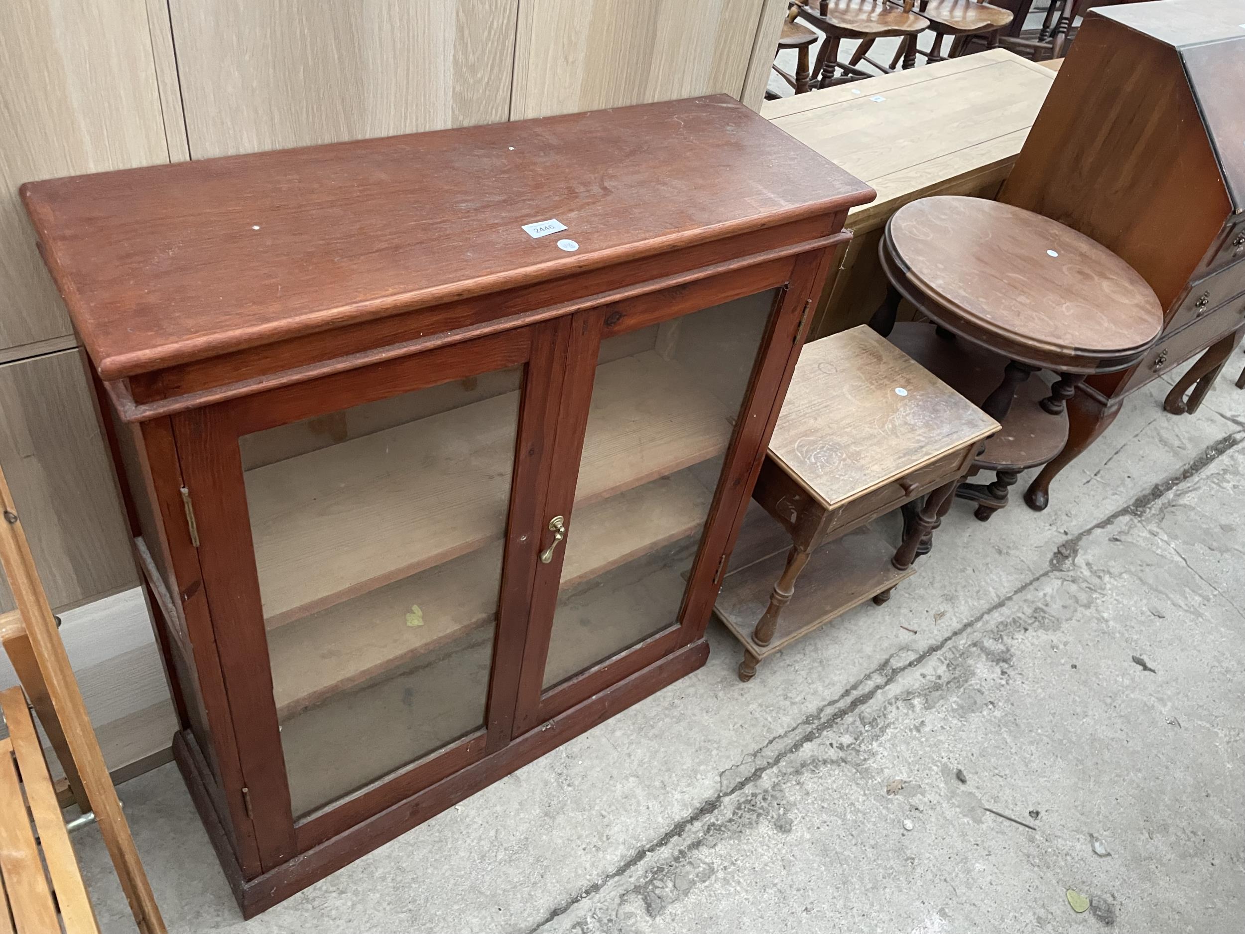 A 20TH CENTURY TWO DOOR GLAZED BOOKCASE, 32" WIDE, LOW BEDSIDE LOCKER AND TWO TIER OCCASIONAL TABLE