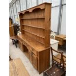 A VICTORIAN STYLE PINE DRESSER ENCLOSING FIVE DRAWERS AND TWO CUPBOARDS TO THE BASE, COMPLETE WITH