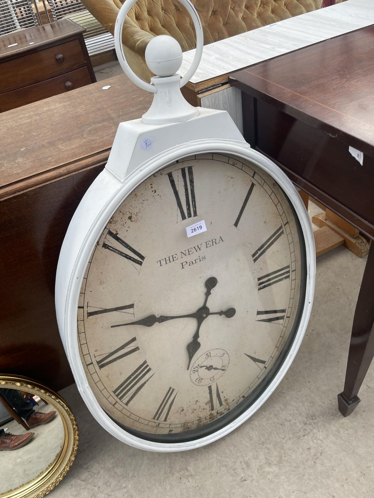 A WALL CLOCK IN THE FORM OF A POCKET WATCH