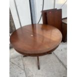 A 19TH CENTURY STYLE MAHOGANY AND CROSSBANDED DINING TABLE, 43" DIAMETER (TWO LEAVES) WITH SHAM