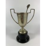 A SMALL TROPHY CUP AWARDED BY LEIGH AND DISTRICT TENNIS LEAGUE IN 1958 HEIGHT 14CM