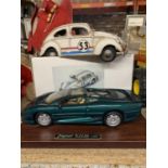 TWO MODEL CARS TO INCLUDE A BEETLE AND A JAGUAR XJ220BON A PLINTH