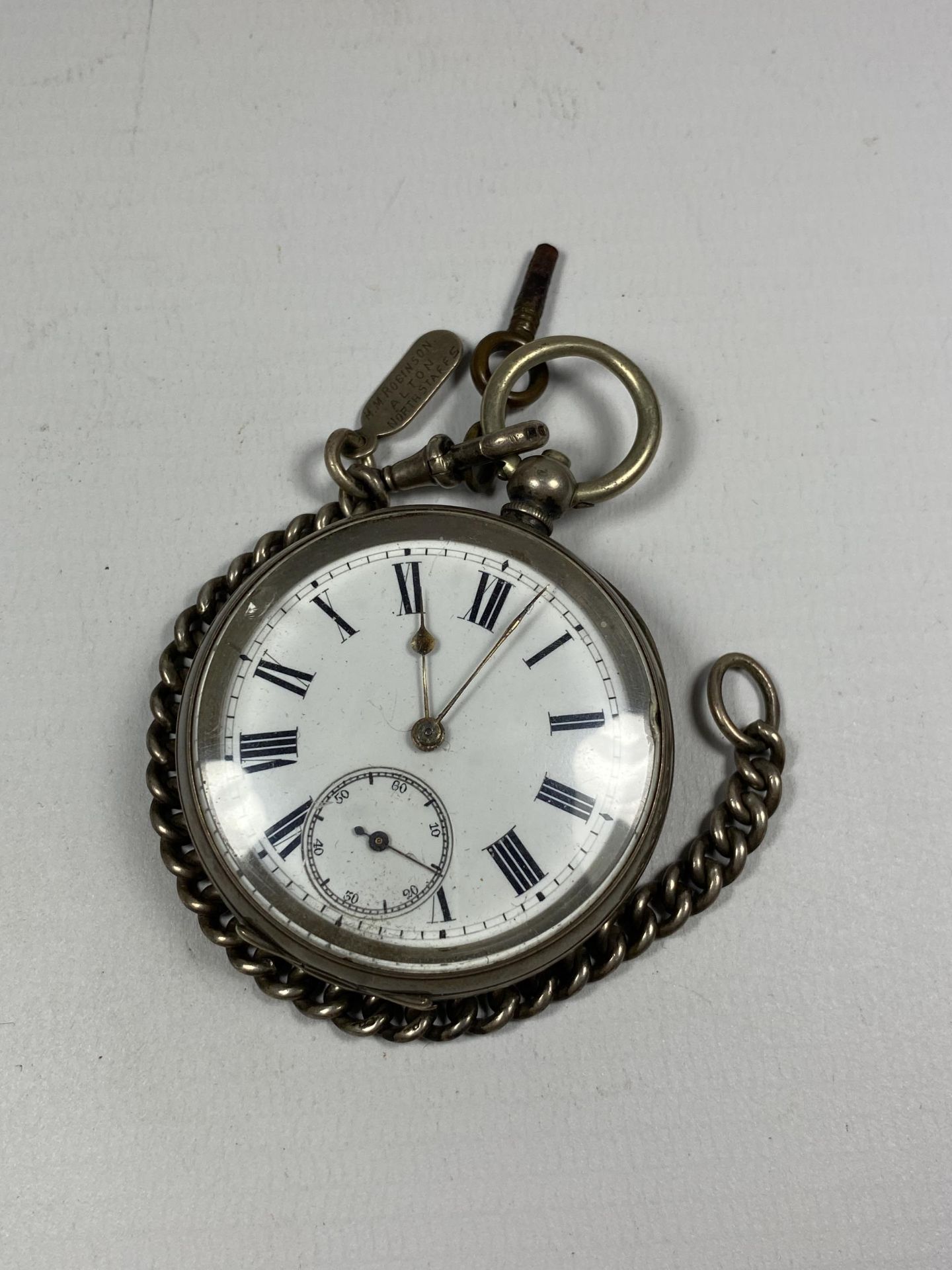 A CONTINENTAL .800 GRADE SILVER OPEN FACED POCKET WATCH WITH SILVER ALBERT CHAIN