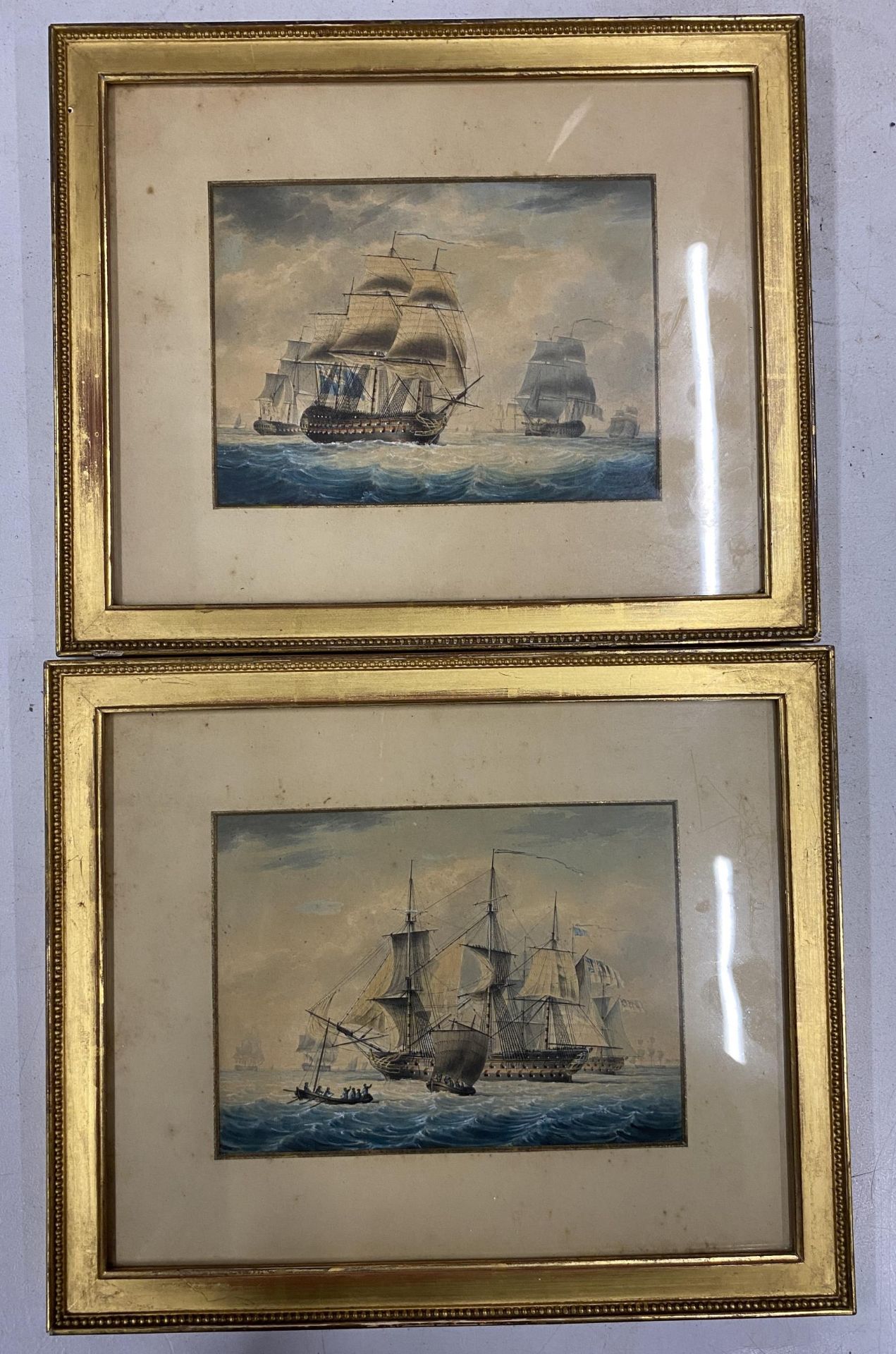 A PAIR OF EARLY 20TH CENTURY MARITIME / NAVAL GILT FRAMED WATERCOLOURS OF SHIPS, LABELS VERSO, 24