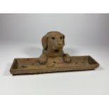 A 19TH CENTURY BAVARIAN BLACK FOREST CARVED DOG INKWELL WITH GENEVE MARK, LENGTH 24.5CM