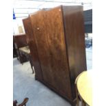 A MID 20TH CENTURY WALNUT THREE DOOR WARDROBE