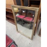 A MODERN GILT FRAMED WALL MIRROR, 40" X 28"