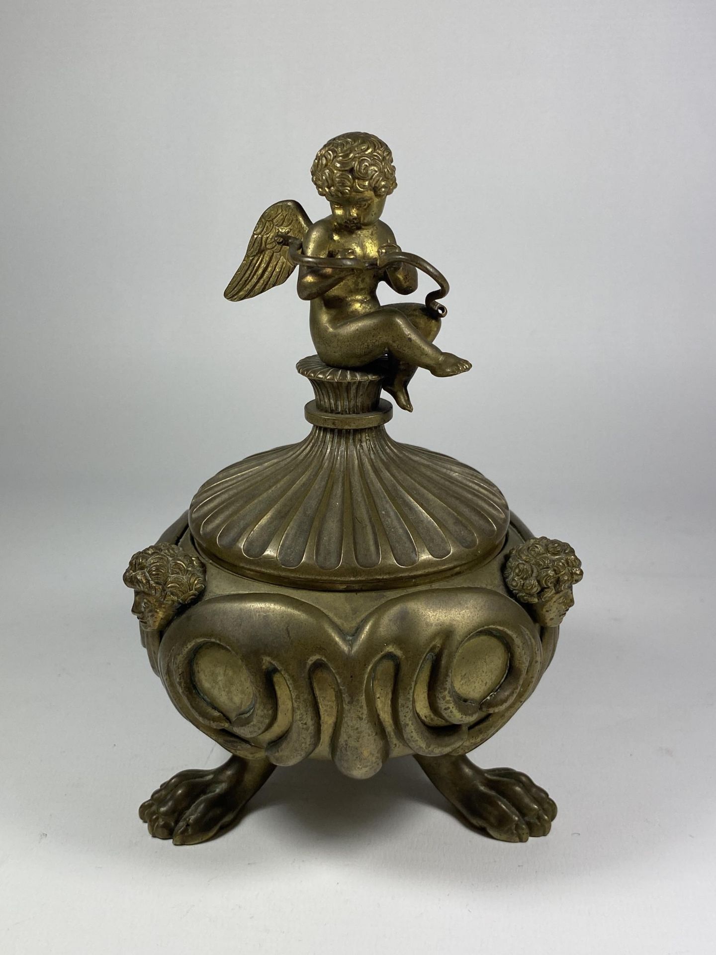A 19TH CENTURY BRASS PETRARCH'S INKSTAND WITH CHERUB DESIGN, INSRIBED TO UNDERISDE OF LID
