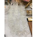 A LARGE QUANTITY OF CUT CRYSTAL GLASSES TO INCLUDE BRANDY BALLOONS, SHERRY, WHISKY, DESSERT BOWLS,