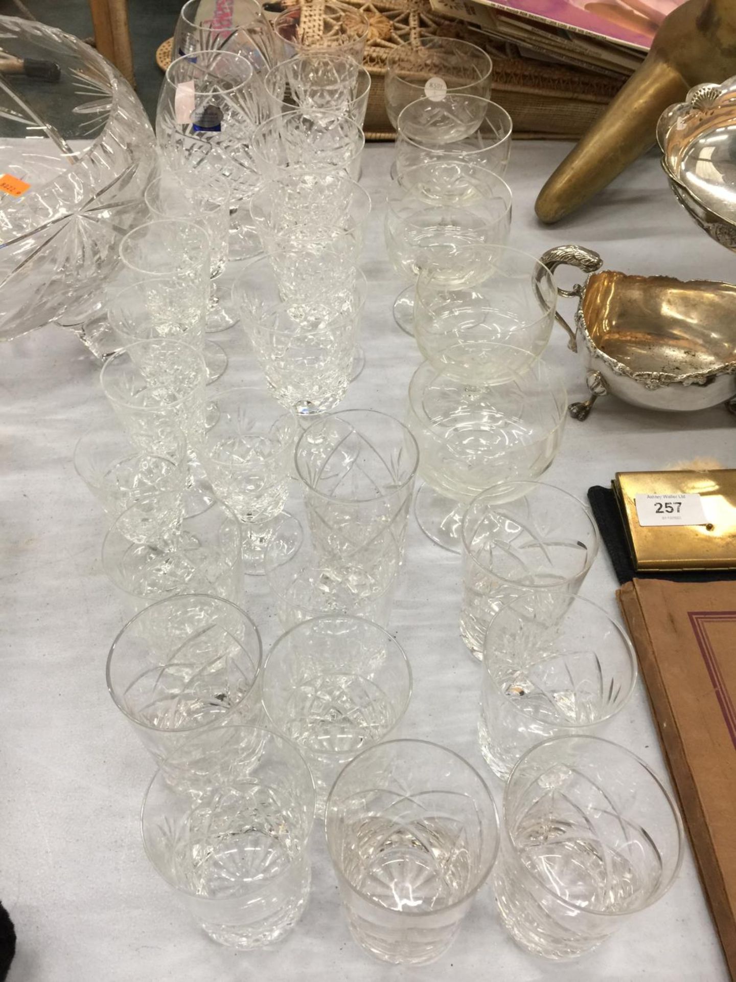 A LARGE QUANTITY OF CUT CRYSTAL GLASSES TO INCLUDE BRANDY BALLOONS, SHERRY, WHISKY, DESSERT BOWLS,