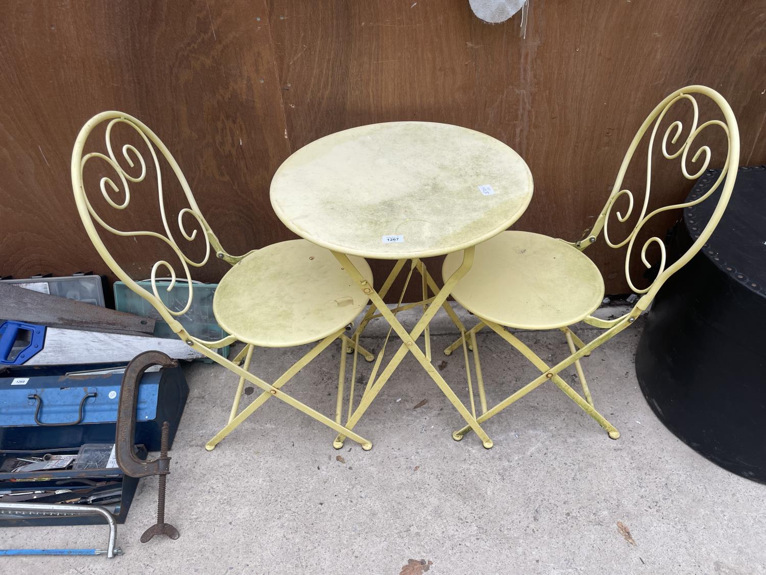 A FOLDING METAL BISTRO SET COMPRISING OF A ROUND TABLE AND TWO CHAIRS
