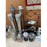 A LARGE ASSORTMENT OF ITEMS TO INCLUDE OUTSIDE LIGHTS, A THREE TIER SHELVING UNIT AND TWO CANDLE
