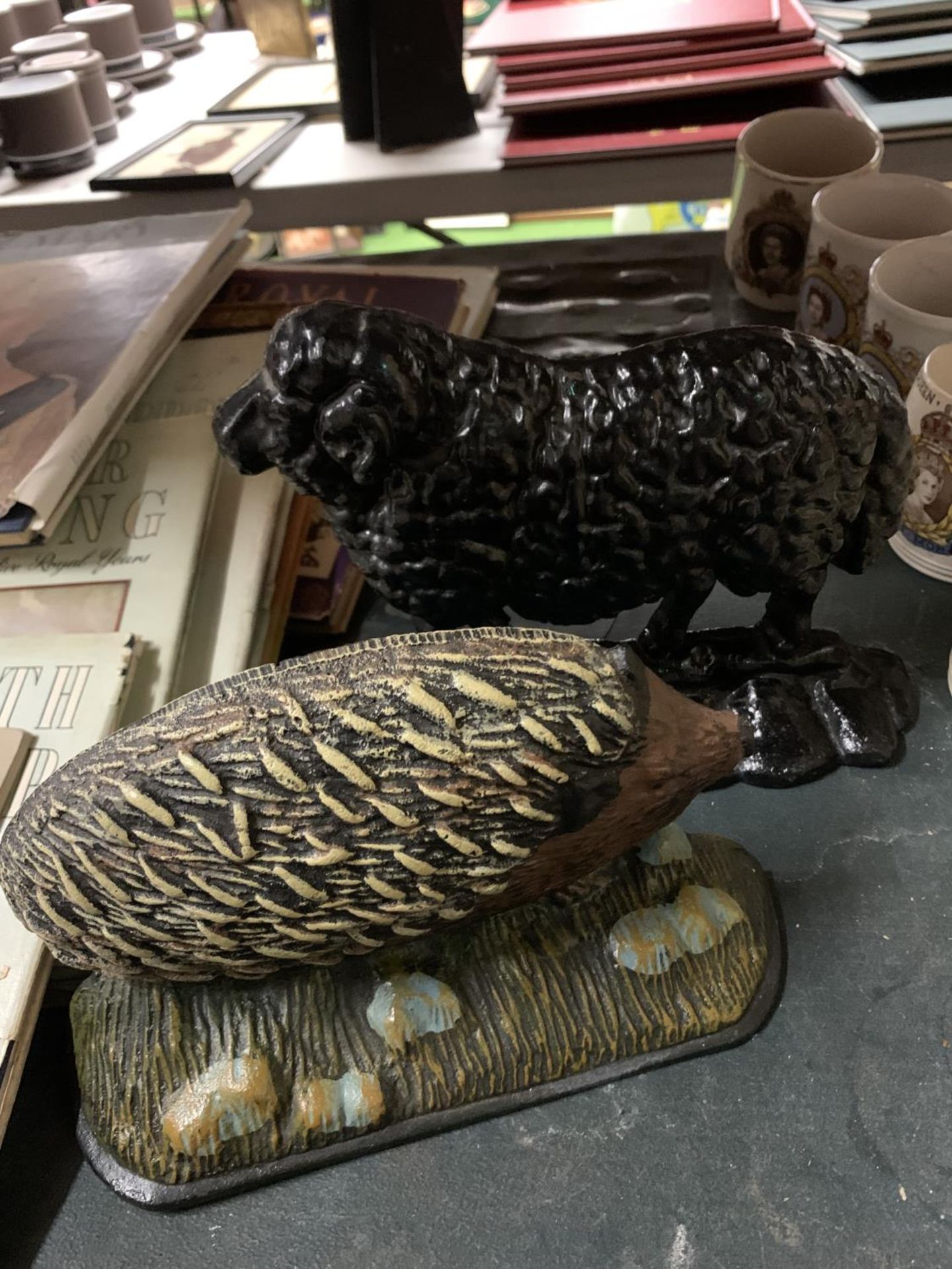 TWO CAST DOORSTOPS, ONE BEING A VINTAGE SHEEP, THE OTHER A HEDGEHOG