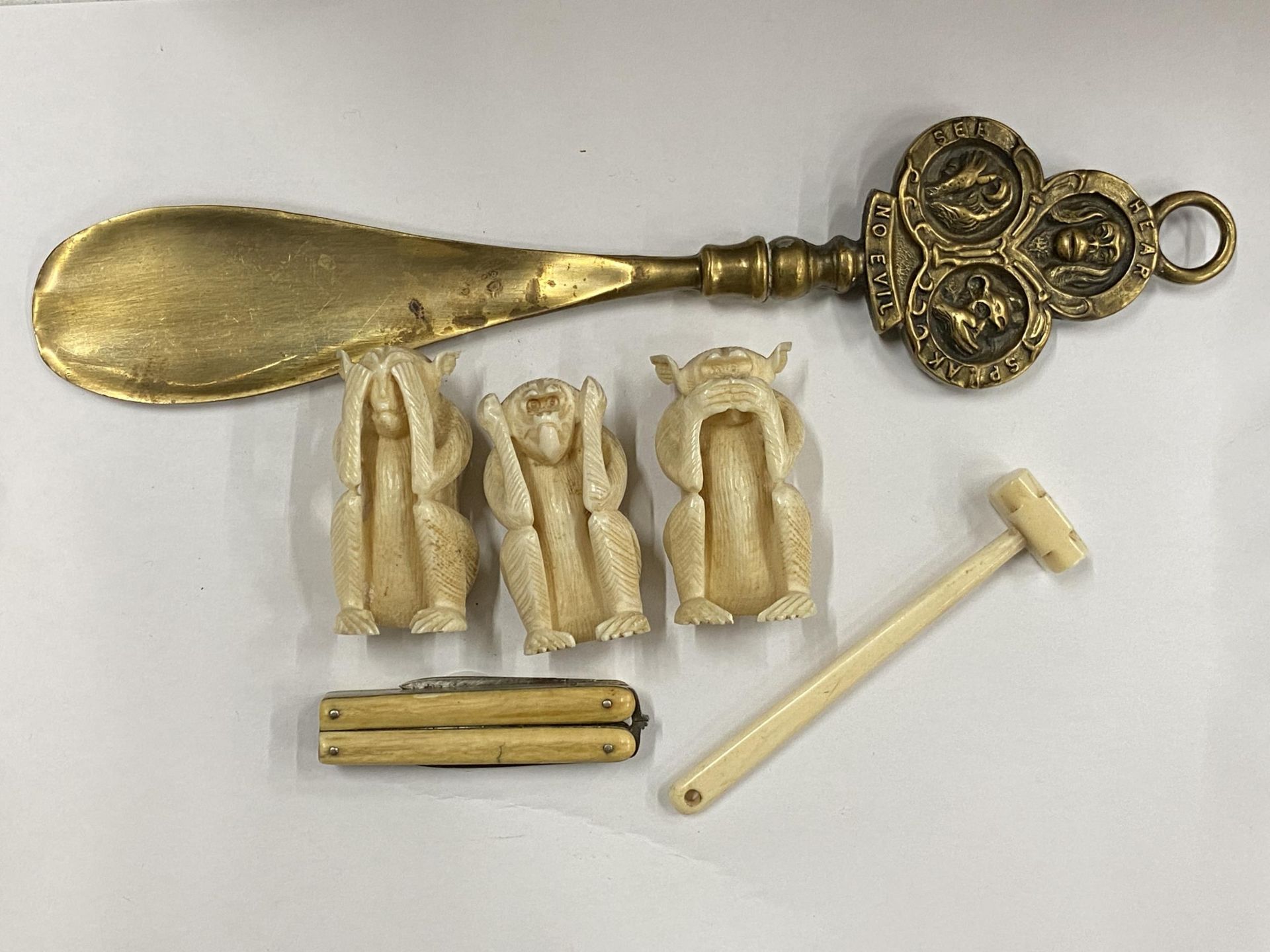 A SET OF THREE BONE SEE NO, HEAR NO, SPEAK NO EVIL MONKEYS, BONE PENKNIFE, HAMMER AND BRASS SHOW