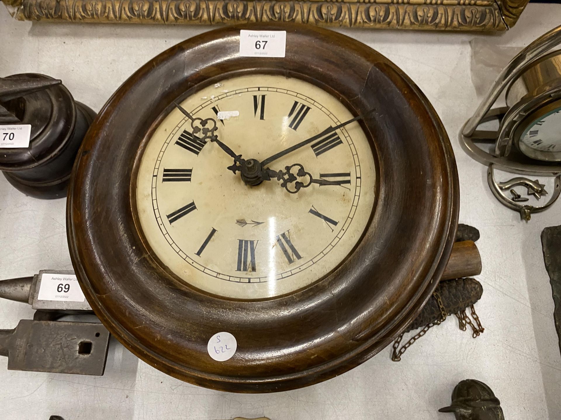 A CIRCULAR WOODEN CLOCKS WITH WEIGHTS