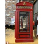 A VINTAGE STYLE TELEPHONE IN A WOODEN TELEPHONE BOX