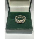 A BAND RING WITH BLUE AND CLEAR STONES MARKED 9CT AND SIL IN A PRESENTATION BOX