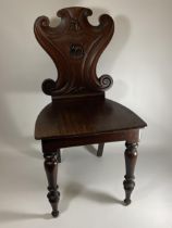 A 19TH CENTURY MAHOGANY CARVED BEDROOM CHAIR WITH ELEPHANT DESIGN BACK