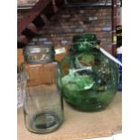 A LARGE GREEN SPHERICAL VASE AND A SMALLER CLEAR ONE
