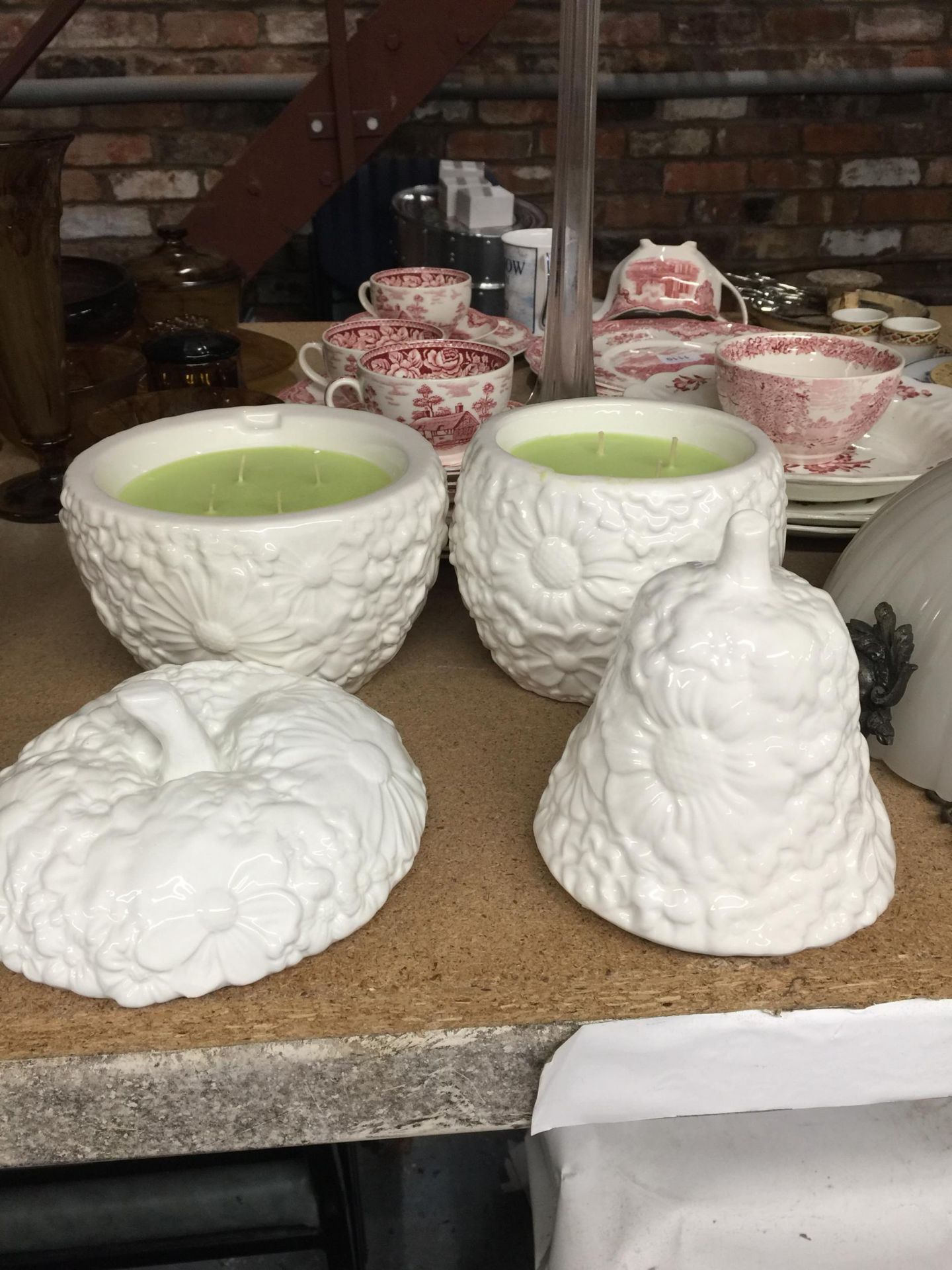 TWO LARGE CANDLE HOLDERS IN THE SHAPE OF AN APPLE AND A PEAR WITH CANDLES