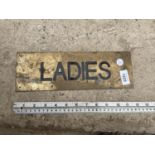 A SMALL BRASS 'LADIES' SIGN (L:30CM)