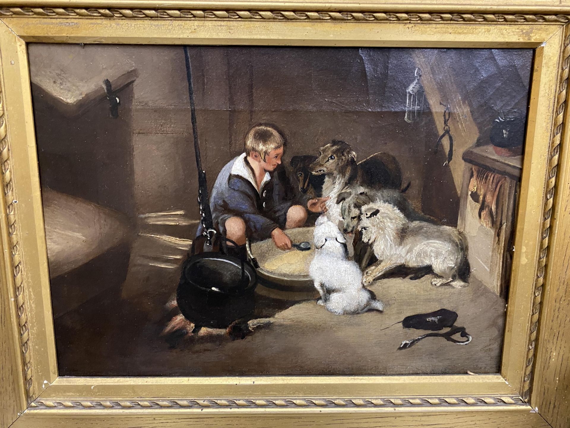 A 19TH CENTURY ENGLISH OIL ON CANVAS OF A STABLE INTERIOR WITH A BOY FEEDING DOGS - Image 2 of 4